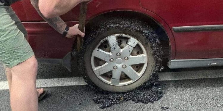 Tar seal stuck to car tyre