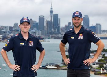 Richie Stanaway and Shane van Gisbergen standing in front of Auckland city