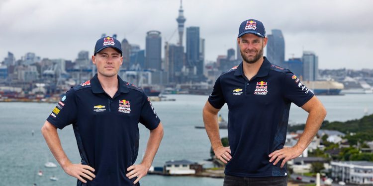 Richie Stanaway and Shane van Gisbergen standing in front of Auckland city