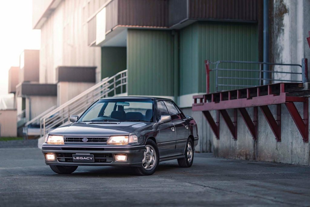 Subaru Legacy RS in front of industrial building