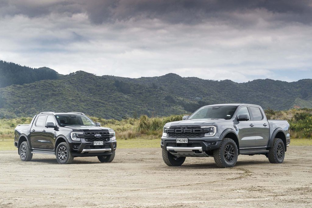 Ford Ranger Raptor vs Ford Ranger Wildtrak with moody sky in background