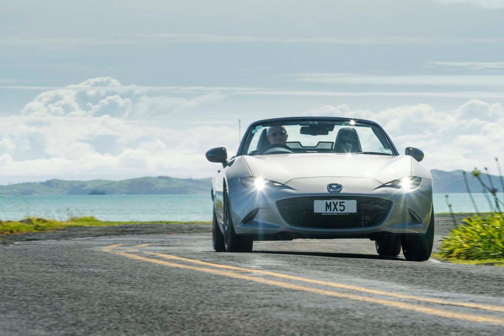 Mazda MX-5 GT driving along coastal road