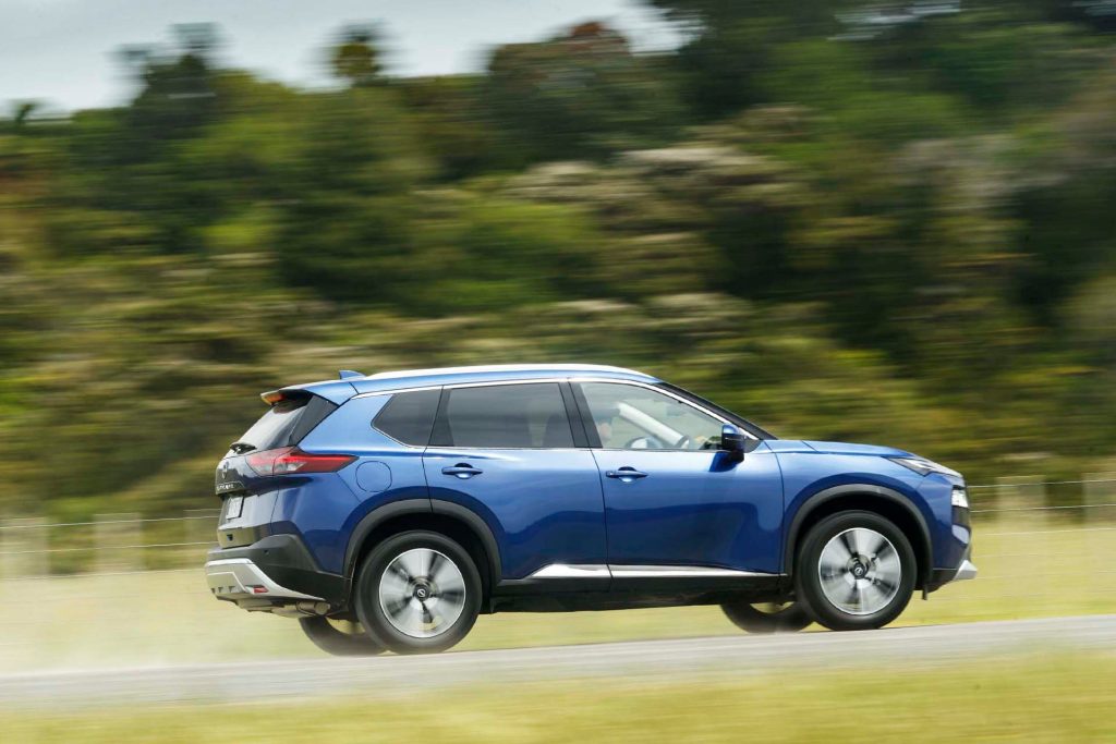 Nissan X-Trail Ti-L driving past trees