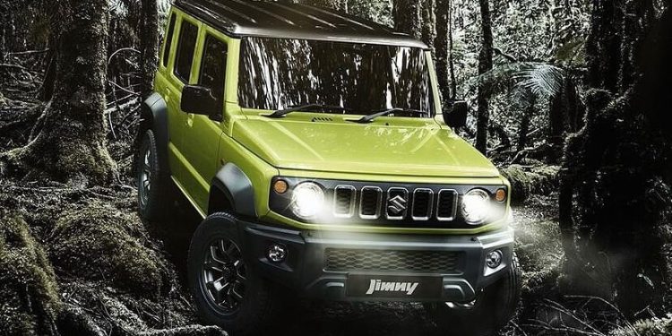 Five-door Suzuki Jimny driving through forest