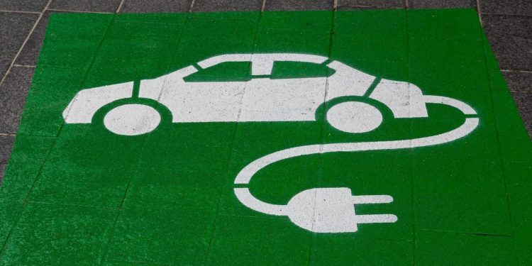 Electric vehicle charging icon on ground