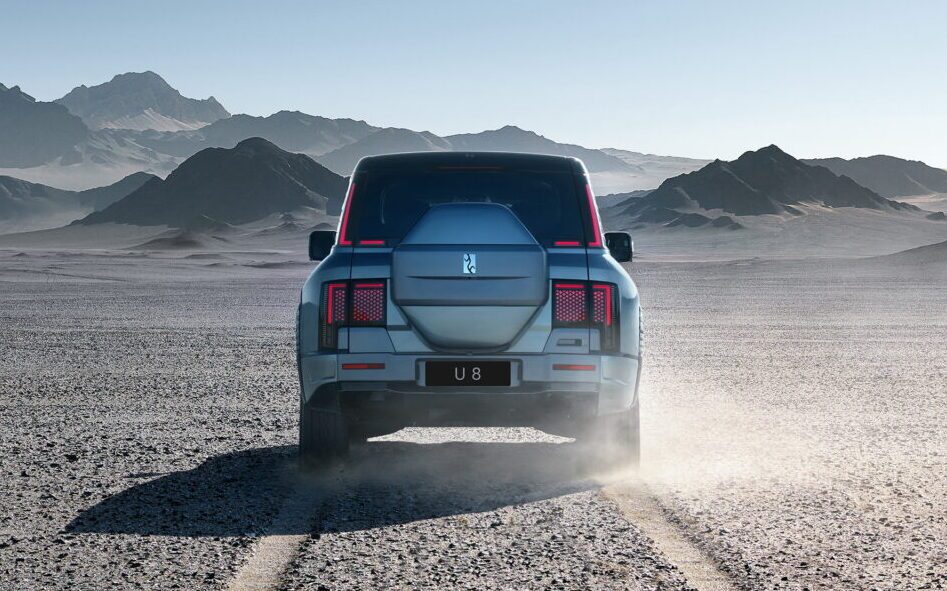 YangWang U8 SUV driving through desert rear view