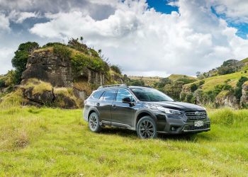 Subaru Outback XT parked in front of roack formations