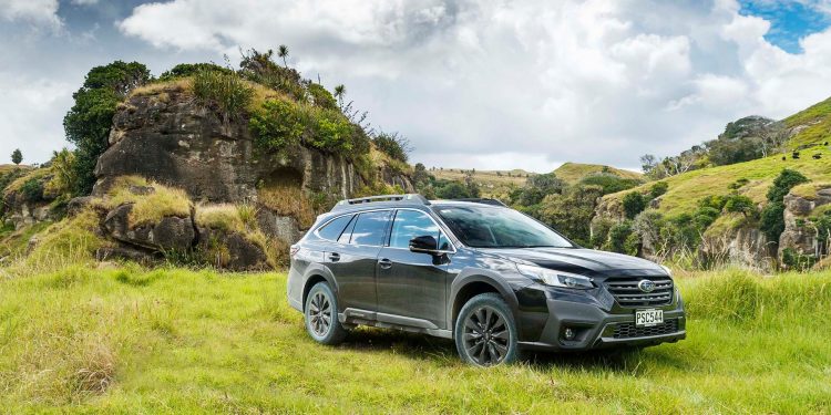 Subaru Outback XT parked in front of roack formations