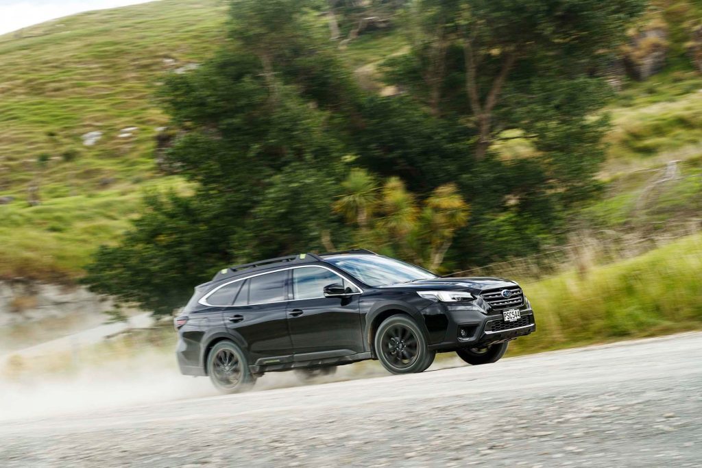 Subaru Outback XT driving fast on gravel
