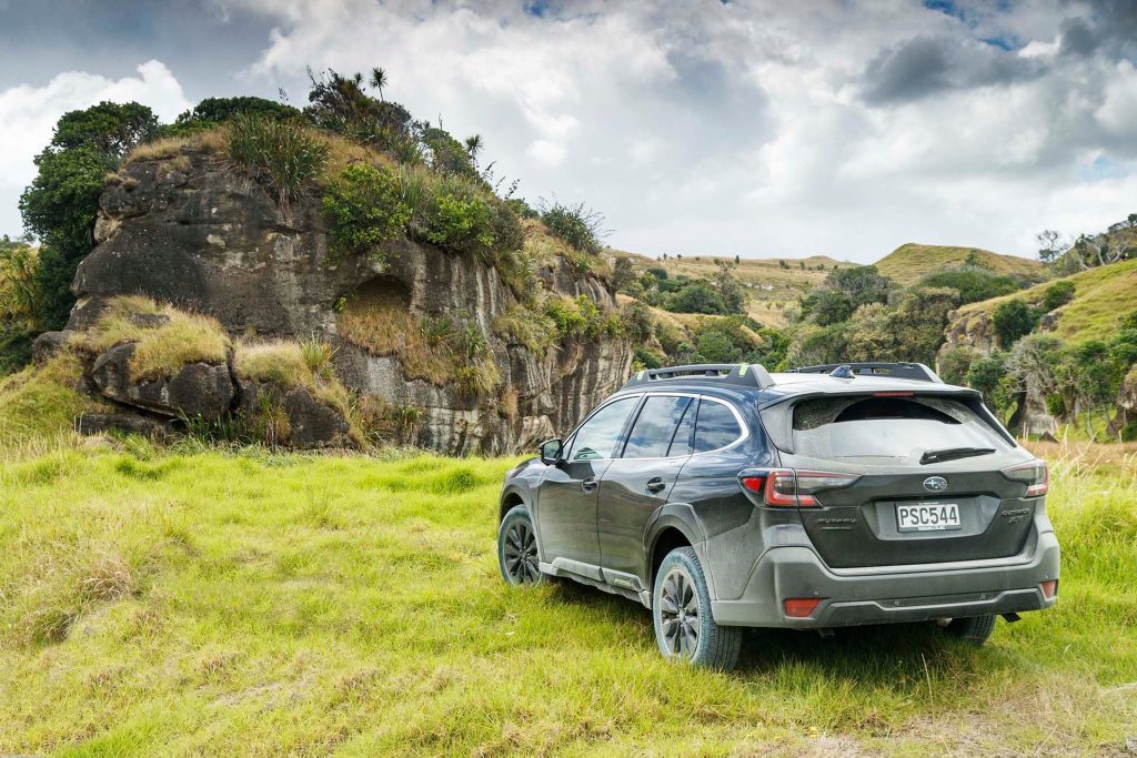 Subaru Outback XT parked near rock formation