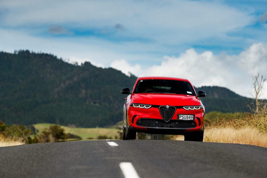 Alfa Romeo Tonale Veloce driving towards viewer. On middle of road