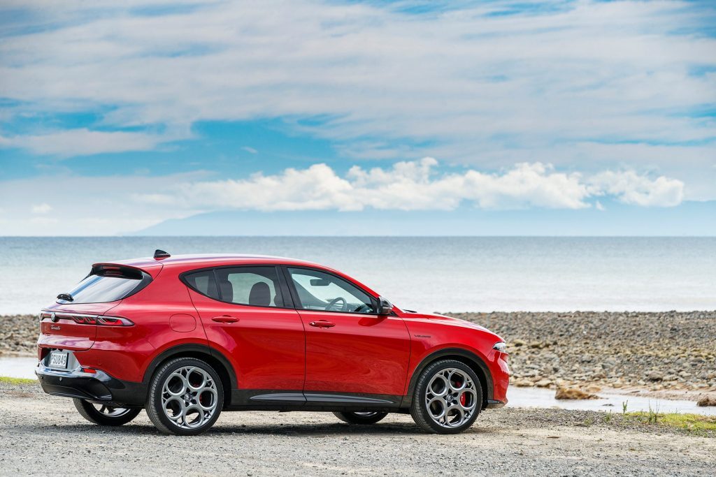 Exterior rear shot of red Alfa Romeo on the beach