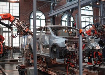 Auto manufacturer factory floor, constructing a car