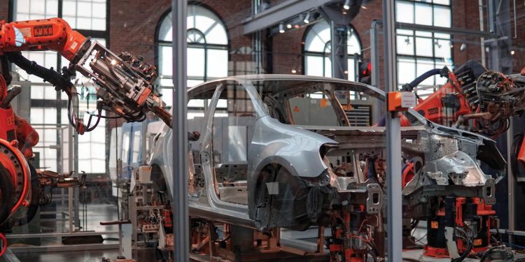 Auto manufacturer factory floor, constructing a car