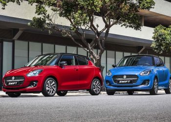 Two Suzuki Swifts parked next to trees