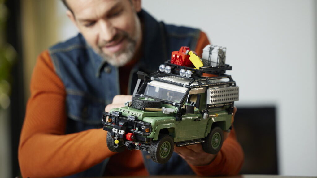Man holding Lego Classic Land Rover Defender 90