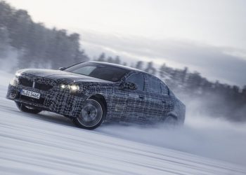 BMW i5 drifting on ice near forest