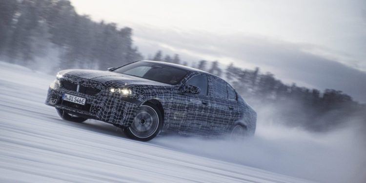 BMW i5 drifting on ice near forest