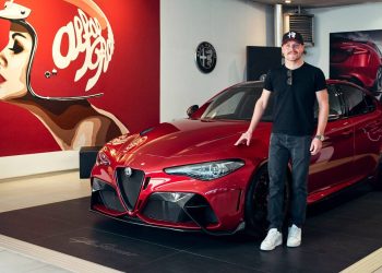 Alfa Romeo F1 Team driver standing next to his new Giulia GTAm