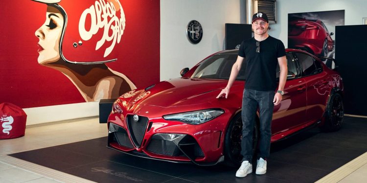 Alfa Romeo F1 Team driver standing next to his new Giulia GTAm