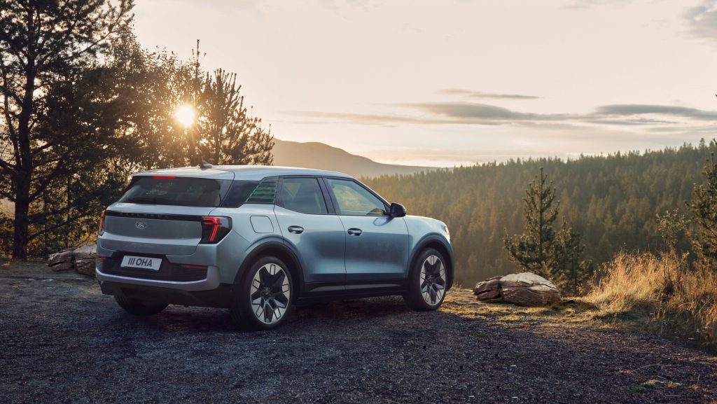 Electric Ford Explorer parked near forest