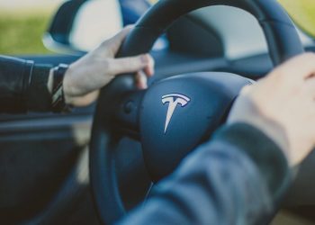 Person holding Tesla steering wheel