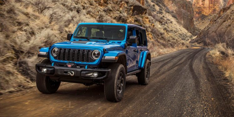 2024 Jeep Wrangler Rubicon X driving on dirt trail