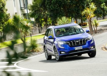 The new Mahindra XUV in a vibrant blue, taking a corner