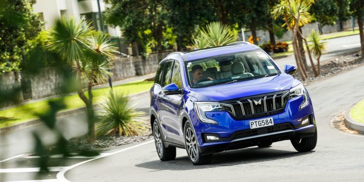 The new Mahindra XUV in a vibrant blue, taking a corner