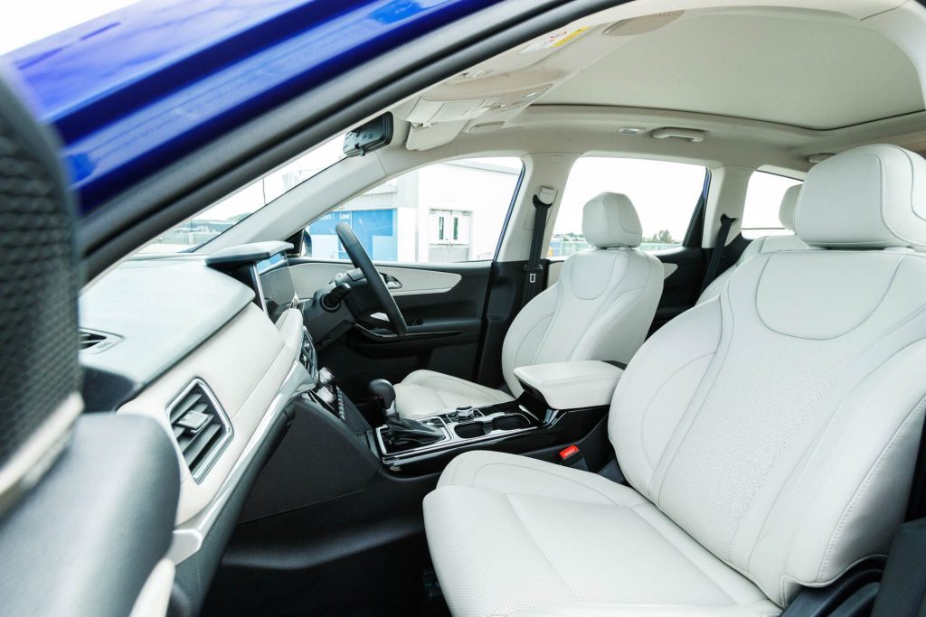 View of the Mahindra interior from the passenger side door, showing front seats