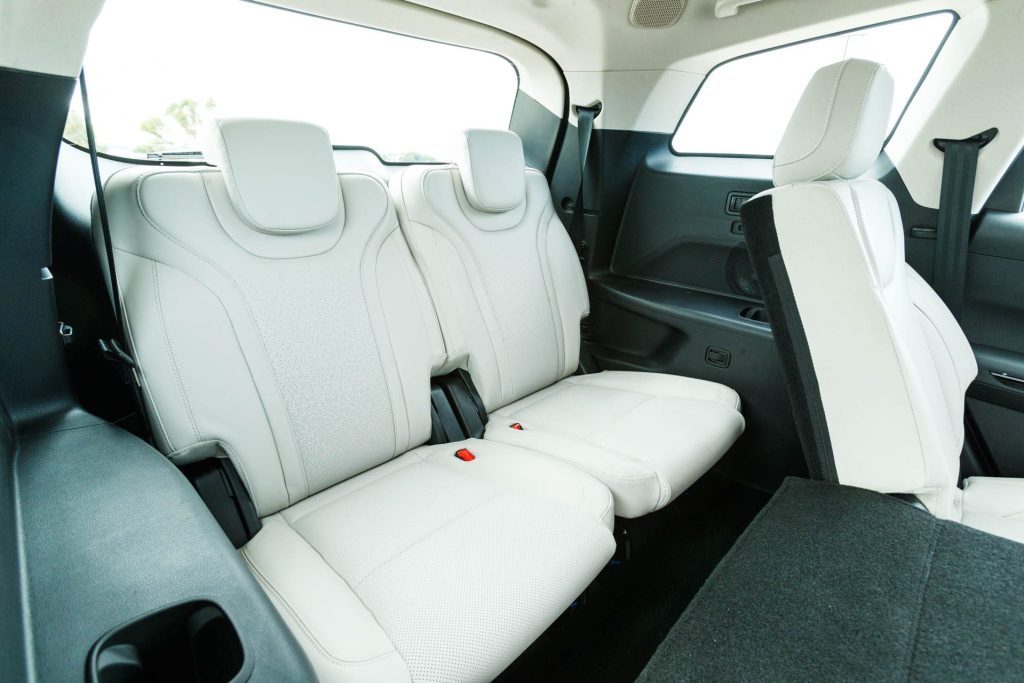 Rear row of white seats, inside the Mahindra XUV