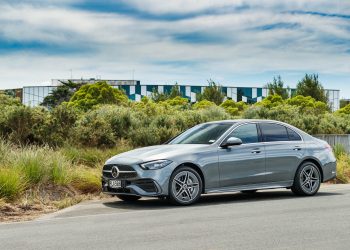 Silver Mercedes C 350e PHEV parked next to a garden