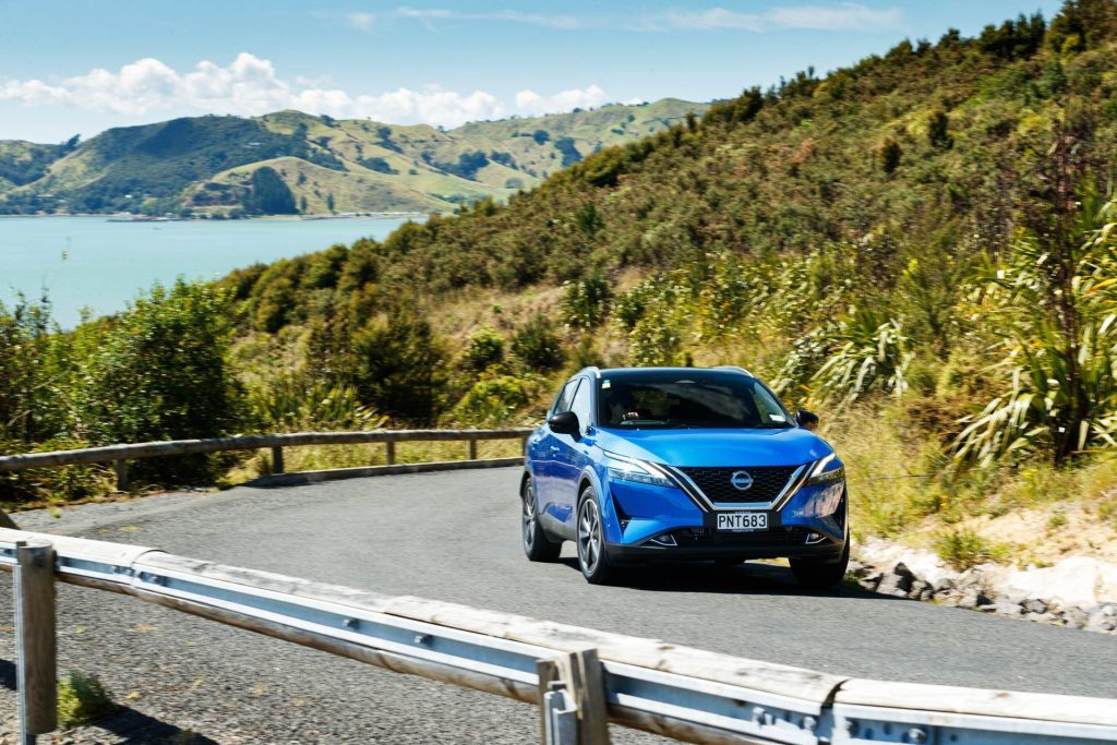 2023 Nissan Qashqai taking a corner on a scenic road