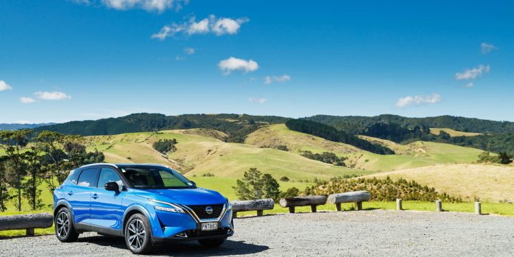 Bright blue Nissan Qashqai, parked on top of a hilltop carpark