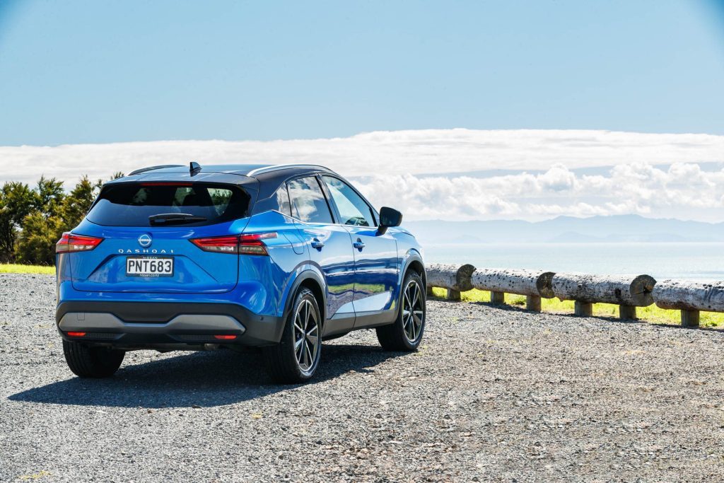Rear quarter of blue Nissan Qashqai, parked on a hill