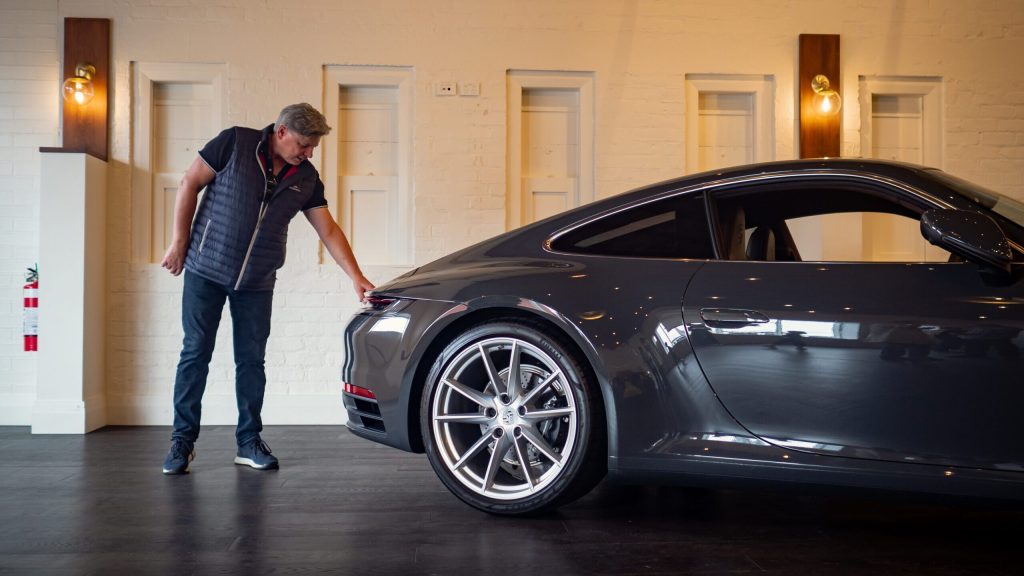 Man touching Porsche 911