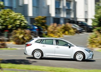 Silver Toyota Corolla GX 2023 wagon driving past