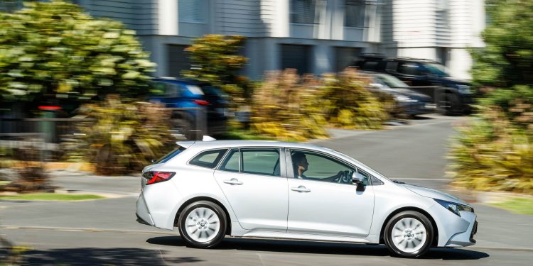 Silver Toyota Corolla GX 2023 wagon driving past