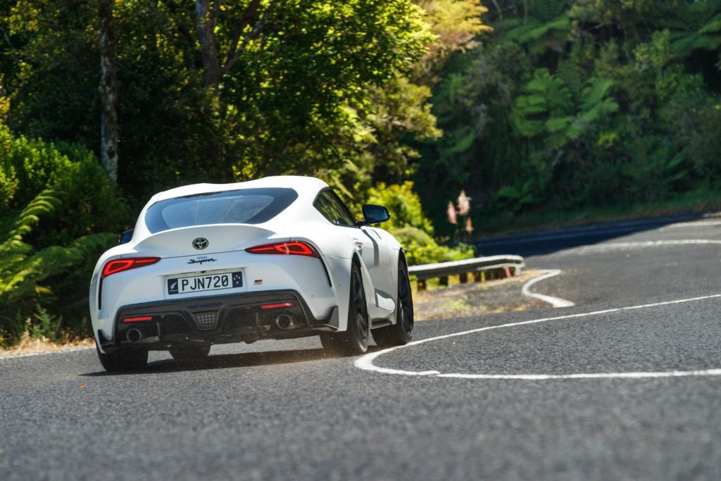 The new GR Supra taking a corner on a twisty road