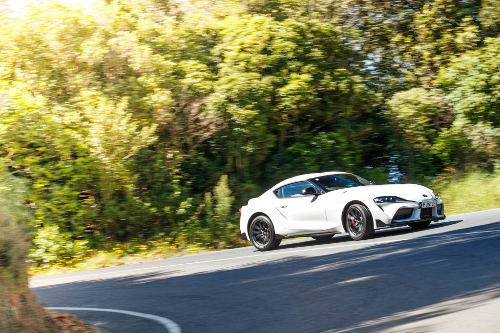 White Toyota GR Supra taking a winding corner