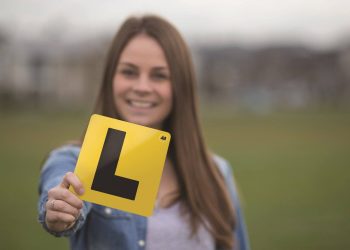 Woman holding learner license plate