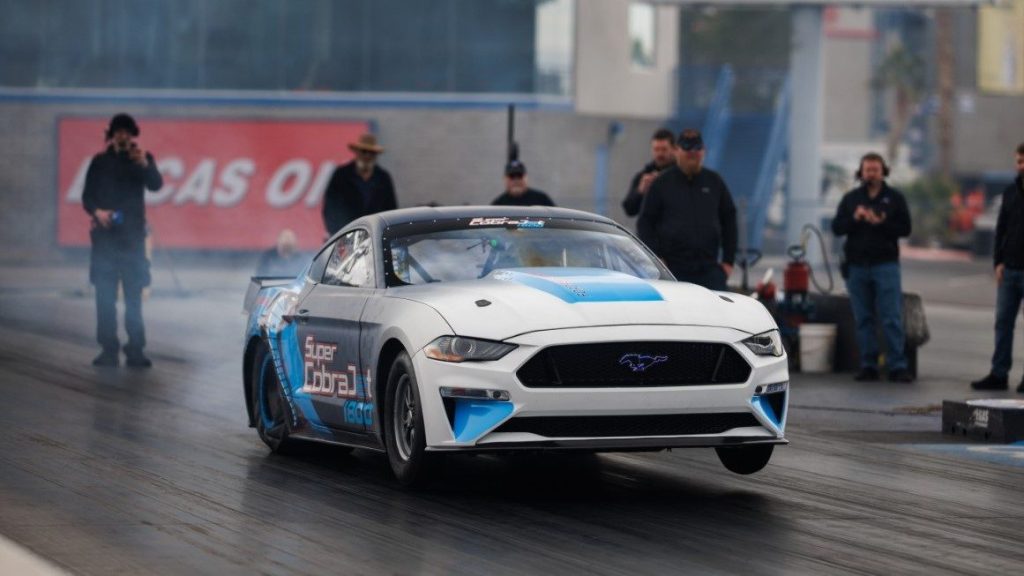 Ford Mustang Super Cobra Jet 1800 doing wheelie on drag strip