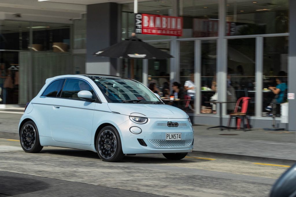 New Fiat 500e Bambina passing Bambina cafe in Newmarket