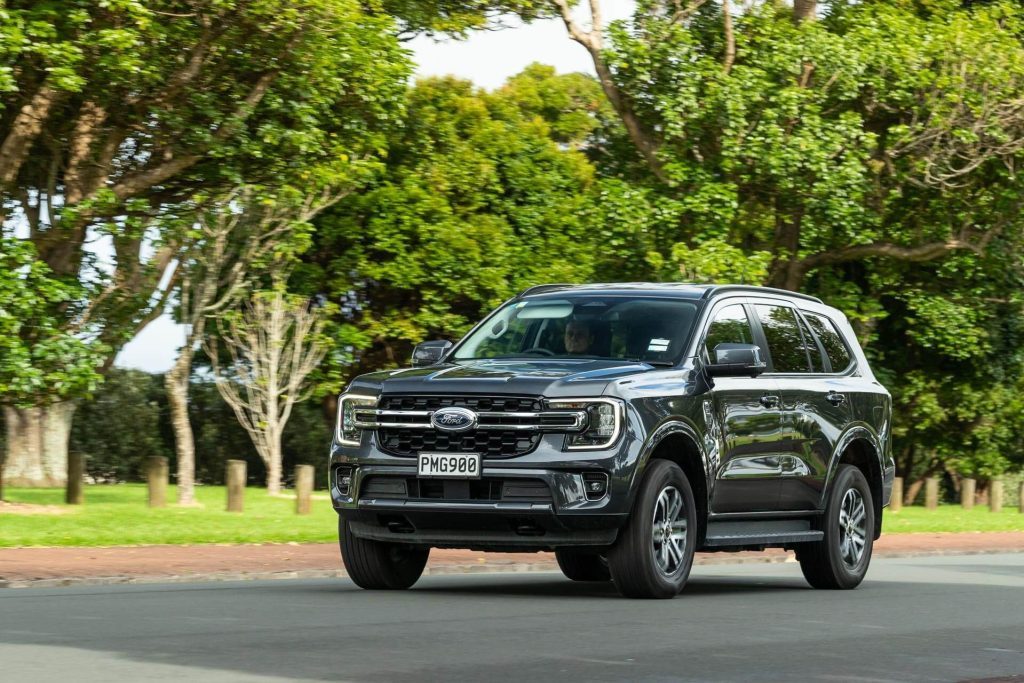 Ford Everest driving past trees