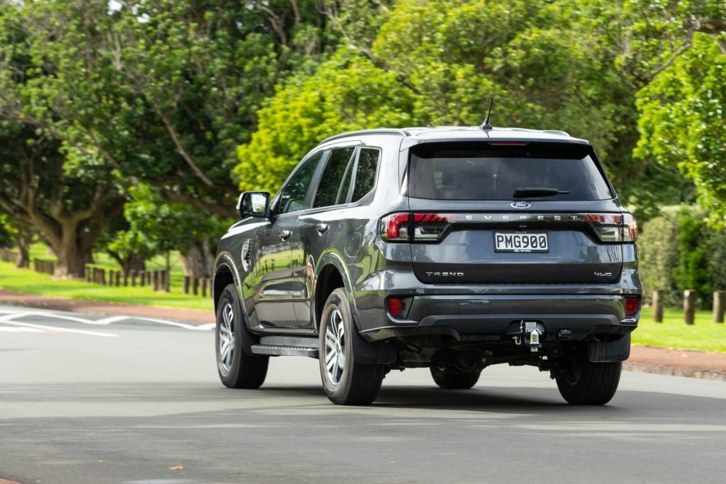 Ford Everest driving past trees