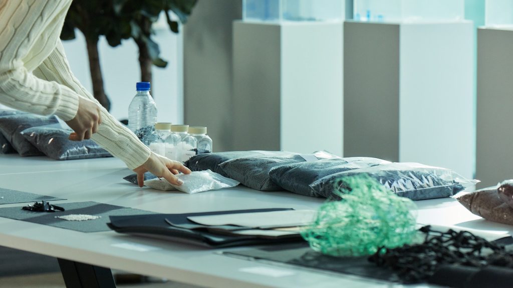 Person touching sustainable materials on table