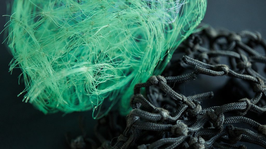 Green and black recycled materials on table