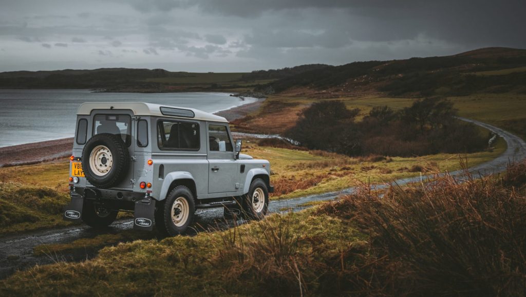 Land Rover Defender Works V8 Islay Edition driving on gravel road