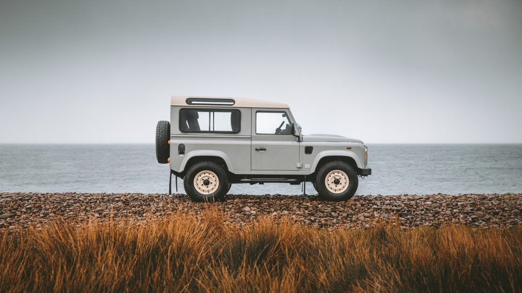 Land Rover Defender Works V8 Islay Edition side view by sea
