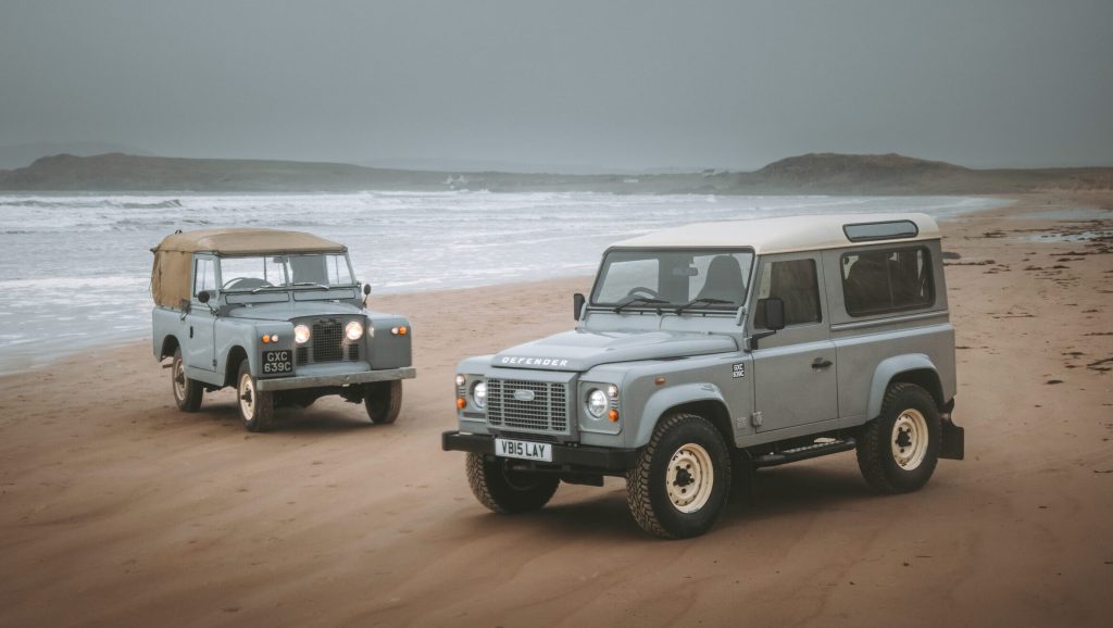 Land Rover Defender Works V8 Islay Edition on beach with original Series 2a